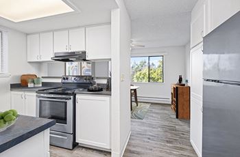A kitchen with stainless steel appliances and white cabinets